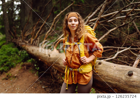 Young woman with backpack traveling outdoors. Hiking, active lifestyle. 126235724