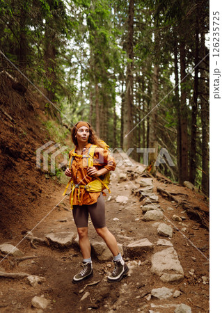 Young woman with backpack traveling outdoors. Hiking, active lifestyle. 126235725