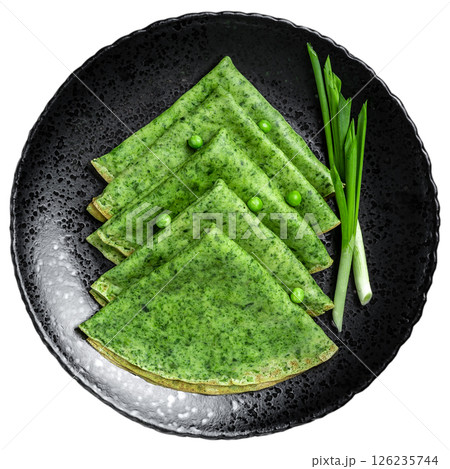 Green vegan crepes pancake with spinach on dark plate. Healthy breakfast isolated on white background. Top view 126235744