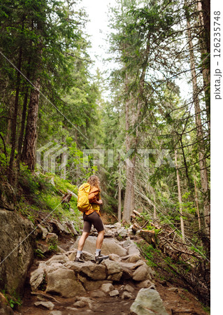 Young woman with backpack traveling outdoors. Hiking, active lifestyle. 126235748