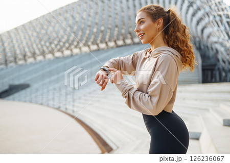 Beautiful woman outdoors and sportswear doing fitness. Concept of sport, recreation. Beautiful woman outdoors and sportswear doing fitness. Concept of sport, recreation. 126236067