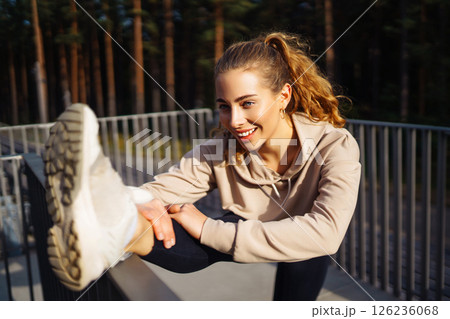 Beautiful woman outdoors and sportswear doing fitness. Concept of sport, recreation. 126236068