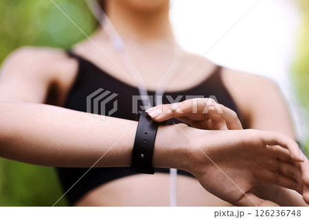 Gadgets For Sport. Female athlete using smartwatch outdoors to track her training progress, closeup image with selective focus 126236748