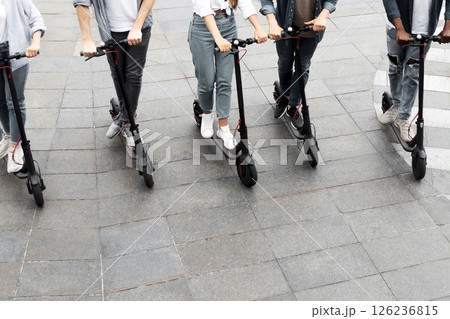 Eco Friendly Transport. Five cheerful smiling multiethnic friends riding e-scooters, high angle view 126236815