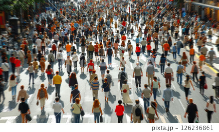 A large group of diverse individuals walking across a busy urban street, some carrying bags and talking on phones. A large group of diverse individuals walking across a busy urban street, some carrying bags and talking on phones. 126236861