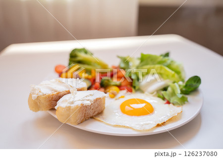 Tasty and healthy breakfast on a plate, scrambled eggs with vegetables, salad and toast, healthy eating and weight loss, weight gain, dietitian nutritionist 126237080