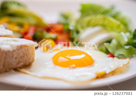 Tasty and healthy breakfast on a plate, scrambled eggs with vegetables, salad and toast, healthy eating and weight loss, weight gain, dietitian nutritionist, Close-up Tasty and healthy breakfast on a plate, scrambled eggs with vegetables, salad and toast, healthy eating and weight loss, weight gain, dietitian nutritionist, Close-up 126237081