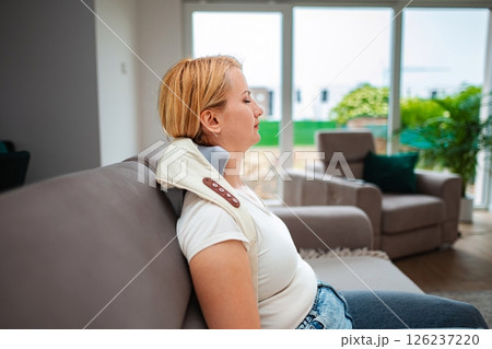 Relaxing moment with neck support in a cozy living room Relaxing moment with neck support in a cozy living room 126237220