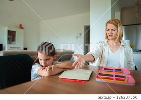 Child and parent in conflict over schoolwork at home Child and parent in conflict over schoolwork at home 126237350