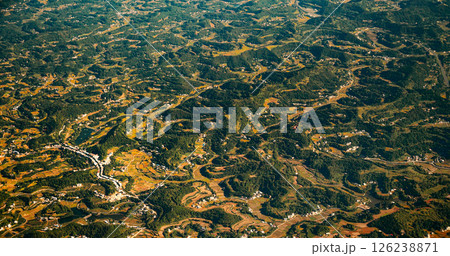View From Airplane Window On Surroundings Of Chengdu, China. Mountainous Wooded Terrain Landscape Of China. Porthole View Or Called Bull's-eye Window. Private Buildings. Discover China View From Airplane Window On Surroundings Of Chengdu, China. Mountainous Wooded Terrain Landscape Of China. Porthole View Or Called Bull's-eye Window. Private Buildings. Discover China 126238871