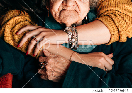 Elderly Woman Embraced by Young Person s Arms 126239648