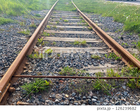 An empty railroad in the city, the iron rails strewn with stones An empty railroad in the city, the iron rails strewn with stones 126239682