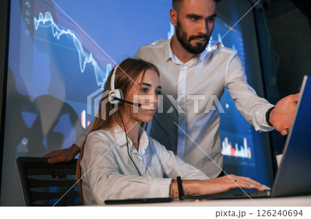 Man and woman is working in the office. Stock brokers using laptop 126240694