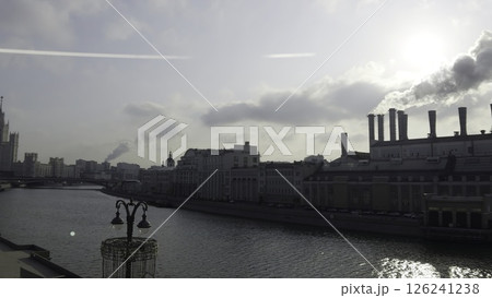 Moscow power plant emitting smoke on moskva river under cloudy sky. Action Moscow power plant emitting smoke on moskva river under cloudy sky. Action 126241238