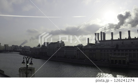 Moscow power plant emitting smoke on moskva river under cloudy sky. Action 126241274