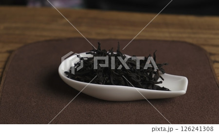 Loose Black Tea Leaves Resting in a Spoon on a Beautiful Wooden Surface for a Natural Look. Media 126241308