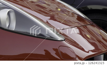 Red sports car reflecting city lights, close up view. Action Red sports car reflecting city lights, close up view. Action 126241323