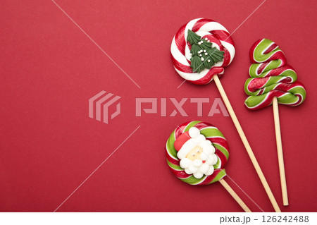 Christmas Candy on red background. Sweet lollipop. 126242488