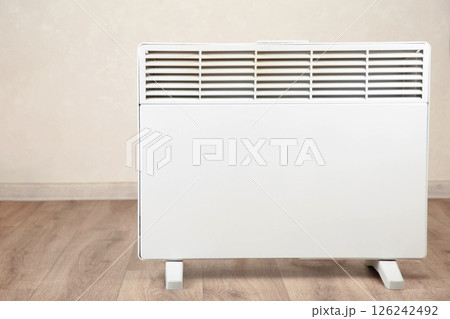 Modern electric heater on floor at home. Top view Modern electric heater on floor at home. Top view 126242492
