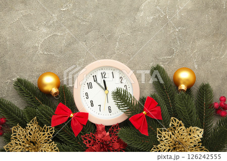 Alarm clock with Santa hat white fir tree on grey background. Alarm clock with Santa hat white fir tree on grey background. 126242555