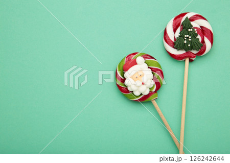 Christmas candy on mint background. Space for text Christmas candy on mint background. Space for text 126242644
