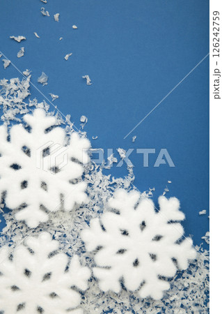 Beautiful snowflakes with snow on blue background. Vertical photo Beautiful snowflakes with snow on blue background. Vertical photo 126242759
