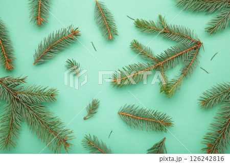 Christmas minimal concept - Christmas composition with fir branch and white bauble on mint background. Christmas minimal concept - Christmas composition with fir branch and white bauble on mint background. 126242816