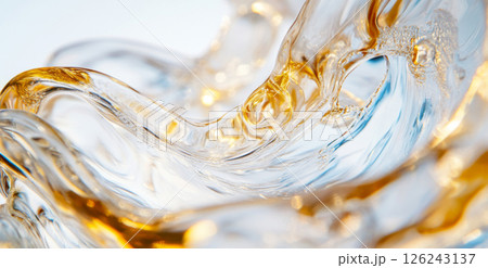 Close-up of liquid flowing on surface with golden hues and abstract shapes 126243137