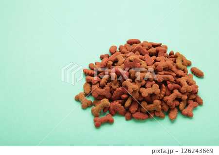 Healthy dry pet food for dogs on mint background. Healthy dry pet food for dogs on mint background. 126243669