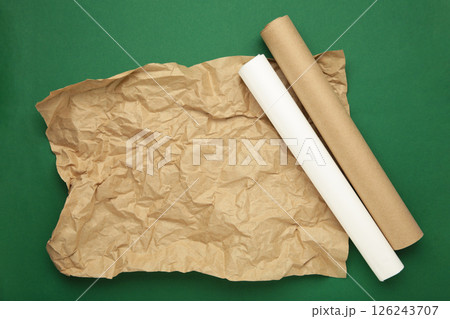Rolls of white and brown baking paper on green background 126243707