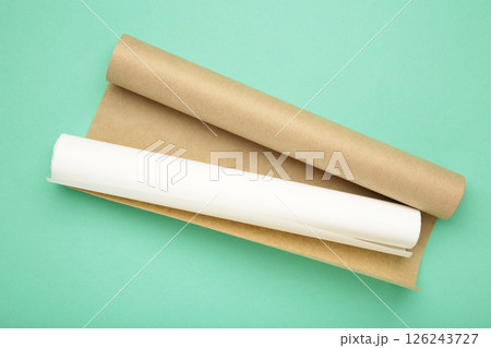 Rolls of white and brown baking paper on mint background Rolls of white and brown baking paper on mint background 126243727