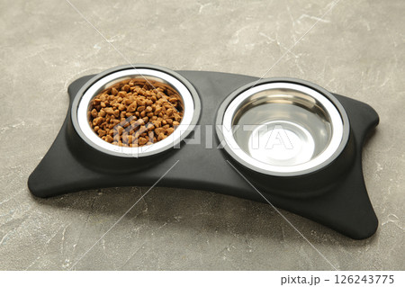 Wet food for dogs and cats in silver bowl on floor kitchen tiles background. 126243775