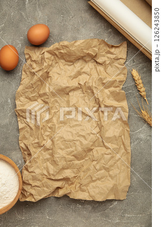 Prepare to baking. Dough ball near cookware on grey concrete background top view. Mock up with baking paper Prepare to baking. Dough ball near cookware on grey concrete background top view. Mock up with baking paper 126243850
