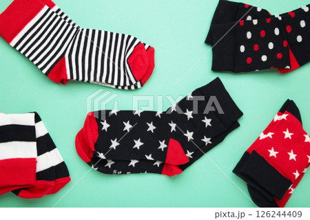 Pair of cute child socks on mint background, top view Pair of cute child socks on mint background, top view 126244409