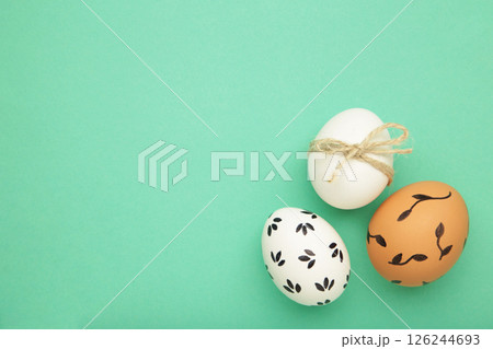 Easter background - white easter egg with flowers inside on mint background. Happy easter, spring, summer floral concept 126244693