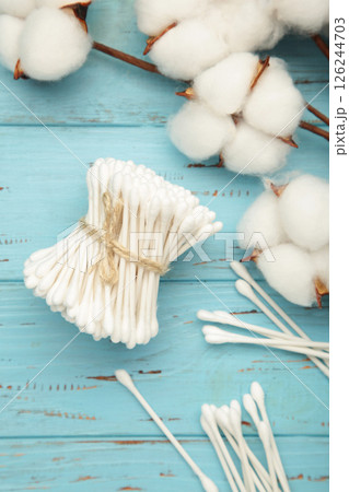 White cotton stricks on blue wooden background. Eco friendly. Hygienic cotton swabs for ears. Top view White cotton stricks on blue wooden background. Eco friendly. Hygienic cotton swabs for ears. Top view 126244703
