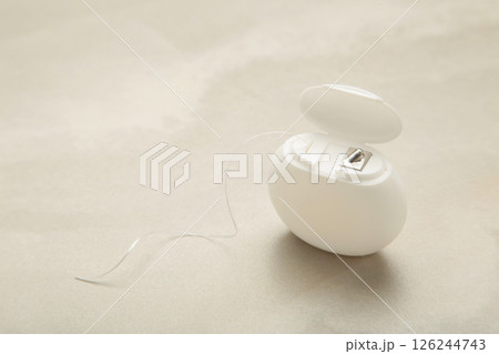 Dental floss on light background. Space for text Dental floss on light background. Space for text 126244743