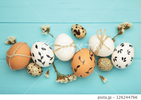 Composition with Easter eggs on blue wooden background Composition with Easter eggs on blue wooden background 126244766