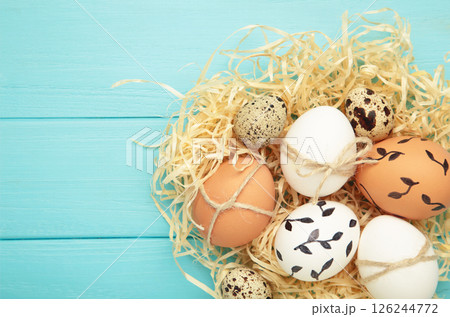 Composition with Easter eggs on blue wooden background 126244772