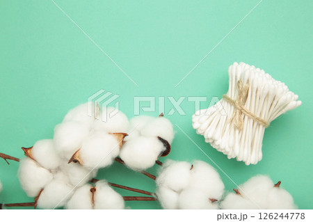White cotton stricks on mint background. Eco friendly. Hygienic cotton swabs for ears. Top view White cotton stricks on mint background. Eco friendly. Hygienic cotton swabs for ears. Top view 126244778