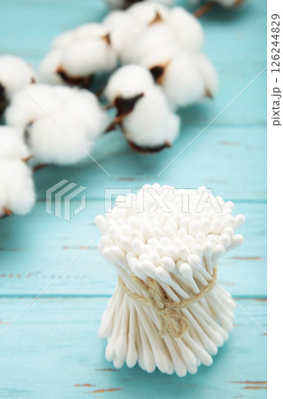 White cotton stricks on blue wooden background. Eco friendly. Hygienic cotton swabs for ears. Top view 126244829