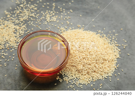 Sesame seeds and sesame oil on dark background. Top view 126244840