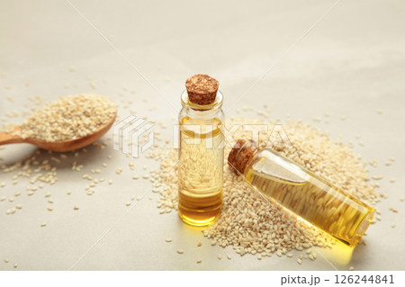 Flaxseeds with flaxseed oil in glass bottle on light background. 126244841