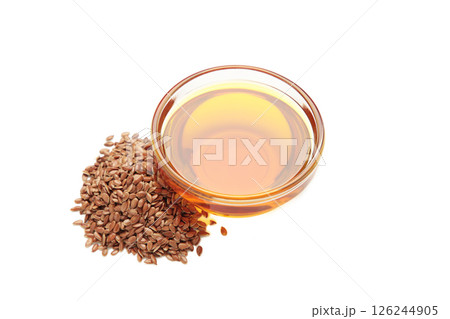 Flaxseeds with flaxseed oil in bowl isolated on white background. 126244905