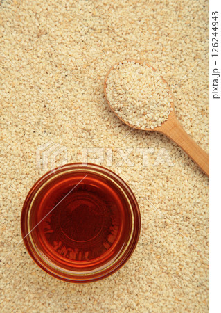 Sesame seeds in spoon and sesame oil. Vertical photo 126244943