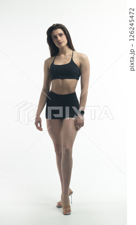 Young beautiful woman with athletic body on white background. Fitness girl 126245472