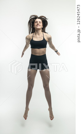 Young beautiful woman with athletic body on white background. Fitness girl 126245473