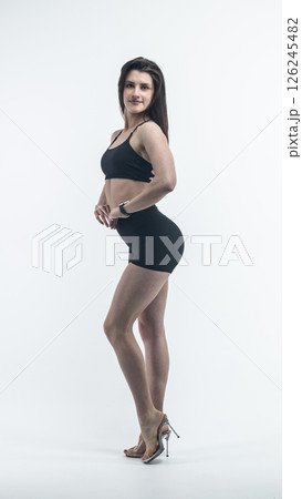 Young beautiful woman with athletic body on white background. Fitness girl Young beautiful woman with athletic body on white background. Fitness girl 126245482