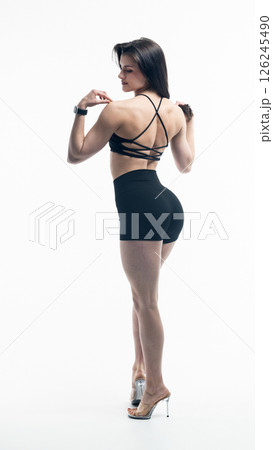 Young beautiful woman with athletic body on white background. Fitness girl Young beautiful woman with athletic body on white background. Fitness girl 126245490