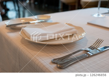 A set of spoon, fork, knife and plate prepared on the table, in the restaurant A set of spoon, fork, knife and plate prepared on the table, in the restaurant 126246856